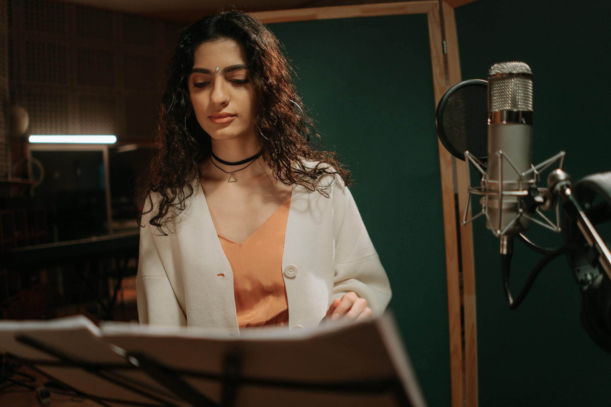 professional female musician recording a song in